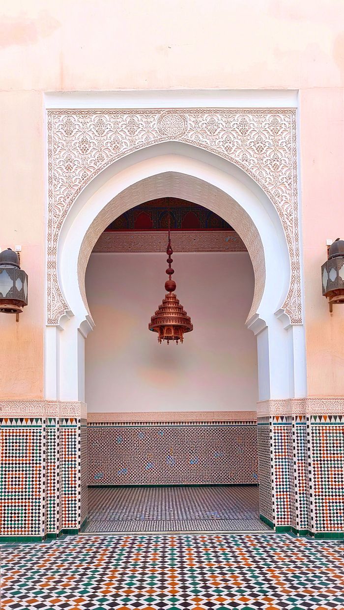service-05 Stunning Moroccan architecture featuring an ornate archway and intricate mosaic tiles.